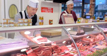Pig meat sales see sharp decline butcher preparing meat behind counter