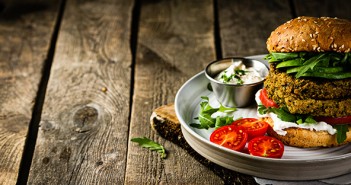 Veganism may have become a religion, but we should still reduce our carbon footprint Vegan zucchini burger and ingredients on rustic wood background