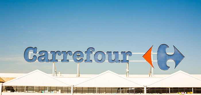 Carrefour supermarket chain brand logo at building