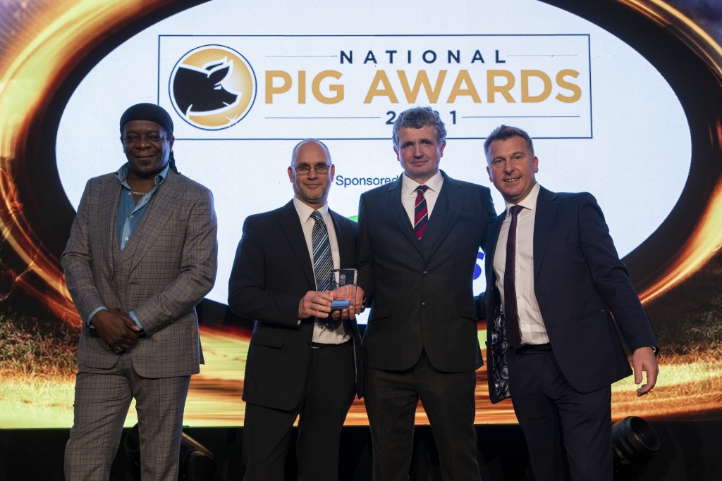 LSB Pigs' Rob McGregor and Robert Battersby received their award from ForFarmers' Craig Saunders  (rt), with host Stephen K Amos, left 